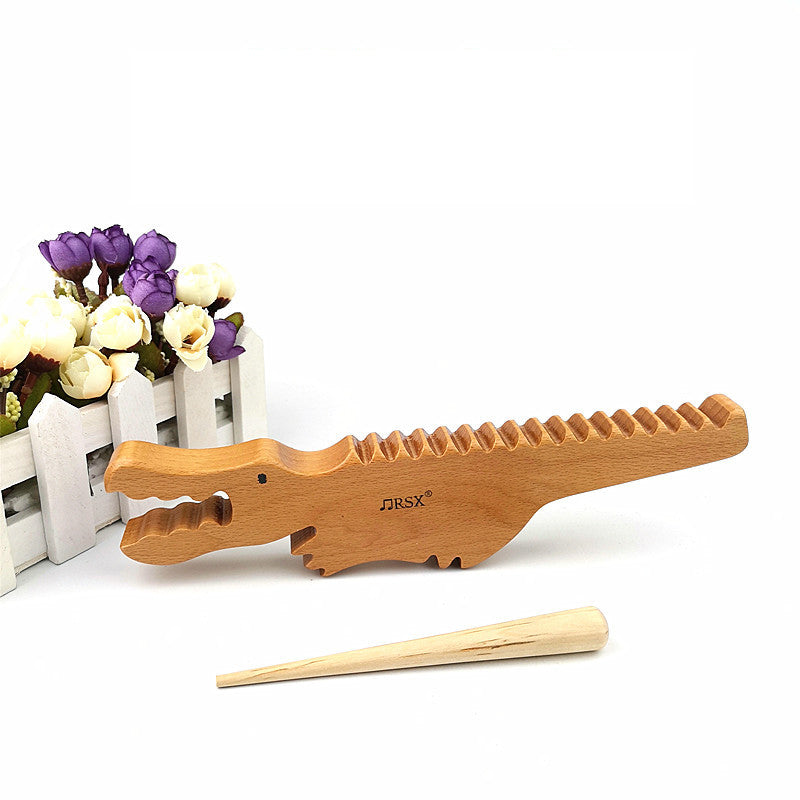 Wooden alligator music toy. Sound sensory exploration toy