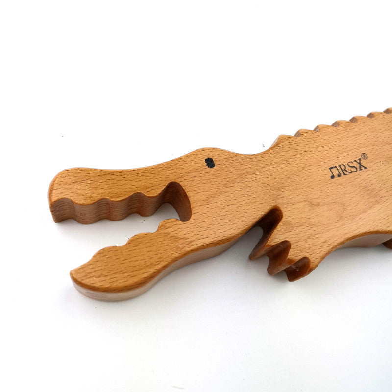 Wooden alligator music toy. Sound sensory exploration toy