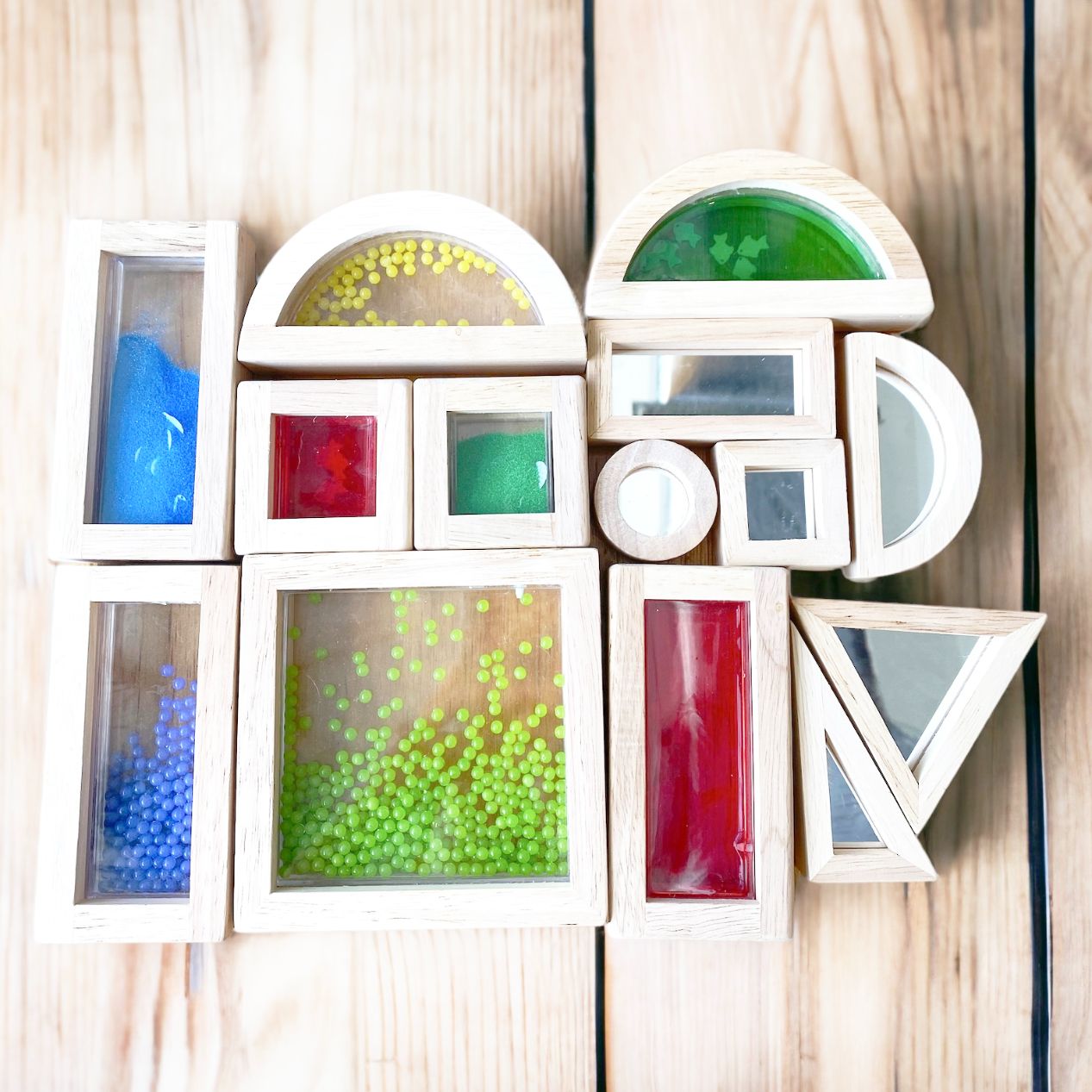Wooden sensory blocks with liquid, sand with shells or beads
